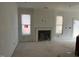 Living room featuring a fireplace, bright windows, and neutral walls at 135 Green Haven Blvd # 1, Youngsville, NC 27596