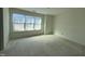Bright room with large window, bare walls, and unfinished flooring at 135 Green Haven Blvd # 1, Youngsville, NC 27596