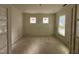 A versatile room with paneled walls, large windows, and unfinished floors at 135 Green Haven Blvd # 1, Youngsville, NC 27596