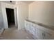A room with white cabinets, bare walls, and unfinished flooring at 135 Green Haven Blvd # 1, Youngsville, NC 27596