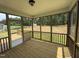 Relaxing screened porch with wooden flooring and view of the expansive green backyard at 135 Green Haven Blvd # 1, Youngsville, NC 27596