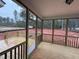 Covered and screened-in porch with wood floor and railing overlooking the backyard at 135 Green Haven Blvd # 1, Youngsville, NC 27596