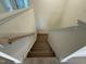 View of the staircase with wood treads, white risers, and handrails at 135 Green Haven Blvd # 1, Youngsville, NC 27596