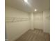 Spacious walk-in closet featuring white wire shelving and neutral carpeting at 135 Green Haven Blvd # 1, Youngsville, NC 27596