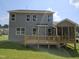 Back view of the house with a large deck, screened porch, and green lawn at 145 Green Haven Blvd # 83, Youngsville, NC 27596