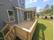 Inviting backyard with a wooden deck, screened-in porch, and lush green lawn at 145 Green Haven Blvd # 83, Youngsville, NC 27596