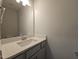Stylish bathroom featuring a quartz countertop, a large mirror, and ample lighting fixtures at 145 Green Haven Blvd # 83, Youngsville, NC 27596