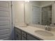Well-lit bathroom showcasing double sinks with quartz counters, vanity cabinet, and a framed mirror at 145 Green Haven Blvd # 83, Youngsville, NC 27596