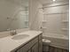 Bathroom showcasing a quartz countertop, single sink vanity, with a tub and shower combination at 145 Green Haven Blvd # 83, Youngsville, NC 27596