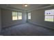 Bedroom with large windows, plush carpeting, and plenty of natural light at 145 Green Haven Blvd # 83, Youngsville, NC 27596