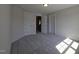Bedroom with plush carpet, bright light and multiple doors giving space and access throughout the home at 145 Green Haven Blvd # 83, Youngsville, NC 27596