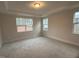Spacious carpeted bedroom illuminated by natural light from multiple windows at 145 Green Haven Blvd # 83, Youngsville, NC 27596