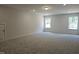 Spacious bonus room with carpet flooring and two windows offering natural light, perfect for entertaining at 145 Green Haven Blvd # 83, Youngsville, NC 27596