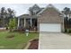Charming two-story home with brick accents, a covered porch, and well-manicured landscaping at 145 Green Haven Blvd # 83, Youngsville, NC 27596