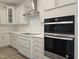 Modern kitchen with stainless steel appliances, sleek cabinets, and tile backsplash at 145 Green Haven Blvd # 83, Youngsville, NC 27596