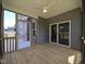 Relaxing screened porch with wood flooring, ceiling fan, and backyard views at 145 Green Haven Blvd # 83, Youngsville, NC 27596