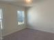 Well-lit bedroom featuring a large window and carpet at 508 Glenwyck Ct, Fuquay Varina, NC 27526