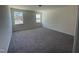 Well-lit bedroom with gray carpeting and two windows at 508 Glenwyck Ct, Fuquay Varina, NC 27526