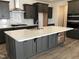 Modern kitchen featuring dark cabinetry, quartz countertops, and stainless steel appliances at 508 Glenwyck Ct, Fuquay Varina, NC 27526