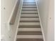 Elegant wooden staircase leading to the upper level at 508 Glenwyck Ct, Fuquay Varina, NC 27526