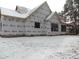 Rear view of house under construction, large windows, house wrap, snow on ground at 1207 Red Cedar Court, Youngsville, NC 27596