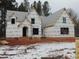 Two-story house under construction, brick exterior, covered porch, snow on ground at 1207 Red Cedar Court, Youngsville, NC 27596