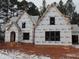Two-story house under construction, brick exterior, covered porch, snow on ground at 1207 Red Cedar Court, Youngsville, NC 27596