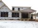 Rear view of house under construction, large windows, covered porch, snow on ground at 1207 Red Cedar Court, Youngsville, NC 27596