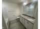 Bathroom featuring double sink vanity, granite countertop, stylish faucets, and a shower-tub combination at 1504 Maelyn Way, Fuquay Varina, NC 27526