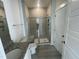 Bathroom features a walk-in shower with light gray tile and a granite-top vanity at 1504 Maelyn Way, Fuquay Varina, NC 27526