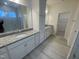 Bathroom features a double vanity with granite countertops and a tiled walk-in shower at 1504 Maelyn Way, Fuquay Varina, NC 27526