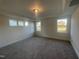 Spacious bedroom with ample natural light from three windows and neutral carpet flooring at 1504 Maelyn Way, Fuquay Varina, NC 27526