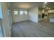 Bright dining room with large sliding glass doors and light wood-look floors open to the kitchen at 1504 Maelyn Way, Fuquay Varina, NC 27526