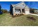 Charming two-story home featuring a brick and gray siding exterior, manicured lawn, and inviting front porch at 1504 Maelyn Way, Fuquay Varina, NC 27526