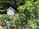 A quaint garden shed complements the vibrant, well-tended vegetable garden, promising fresh produce at 1504 Maelyn Way, Fuquay Varina, NC 27526