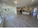 Open kitchen featuring an island, stainless steel appliances, light cabinets, and hardwood floors at 1504 Maelyn Way, Fuquay Varina, NC 27526