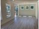 Bright living room with hardwood floors, large windows, and a glass door to a patio at 1504 Maelyn Way, Fuquay Varina, NC 27526