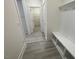 Bright mudroom featuring built-in storage bench, coat hooks, and easy access to the home's interior at 1504 Maelyn Way, Fuquay Varina, NC 27526