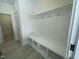 Mudroom features white built-in storage bench with hooks and cubbies adjacent to a pantry at 1504 Maelyn Way, Fuquay Varina, NC 27526