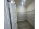 Walk-in pantry with white wire shelving and light wood-look floors at 1504 Maelyn Way, Fuquay Varina, NC 27526