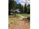 A playground area set amongst tall trees, offering a serene and natural setting for recreation at 1504 Maelyn Way, Fuquay Varina, NC 27526