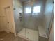 Stylish glass-enclosed shower with tile surround, built-in niche, and bench at 1504 Maelyn Way, Fuquay Varina, NC 27526