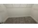 A large, walk-in closet with neutral carpet and a wire rack ready to organize your wardrobe and accessories at 1504 Maelyn Way, Fuquay Varina, NC 27526