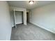 Well-lit bedroom featuring a large closet and carpet flooring at 339 Bishop Ln, Sanford, NC 27330