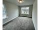 Charming bedroom with a window, carpet, and closet at 339 Bishop Ln, Sanford, NC 27330