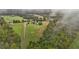 Lush acreage including multiple homes, a pond, extensive landscaping, and verdant forests at 4600 Scottland Dr, Mebane, NC 27302