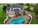 Aerial view of a home with a pool, deck, and landscaped backyard at 4600 Scottland Dr, Mebane, NC 27302