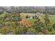 Expansive estate with a large home, pool, and landscaping surrounded by lush greenery and a serene pond at 4600 Scottland Dr, Mebane, NC 27302