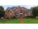 Charming brick home with manicured lawn and symmetrical design elements at 4600 Scottland Dr, Mebane, NC 27302