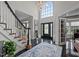Elegant foyer with staircase, chandelier, and decorative glass front door at 4600 Scottland Dr, Mebane, NC 27302